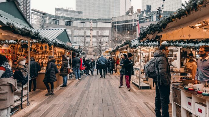 Busy holiday market full of shoppers, highlighting the importance of remaining top of mind through social media strategy for holiday shopping.